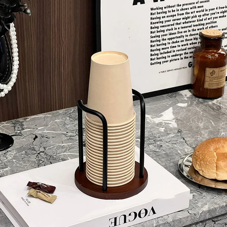 Single bamboo and wood cup stand filled with disposable cups on a marble surface