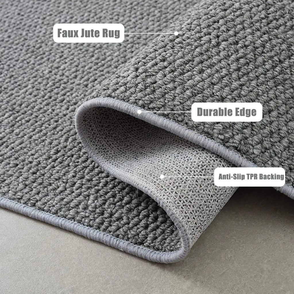 Closeup of gray textured mat showing faux jute look, durable edge, and anti-slip backing