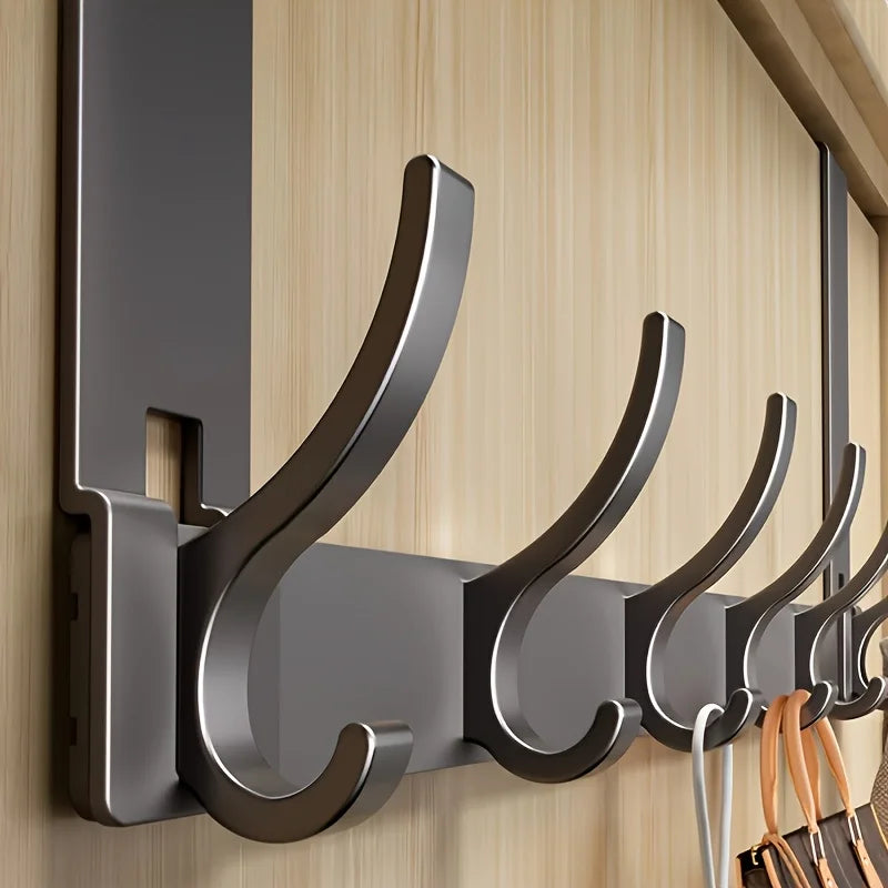 closeup of metal over-the-door hook rack on wood door showing hook detail