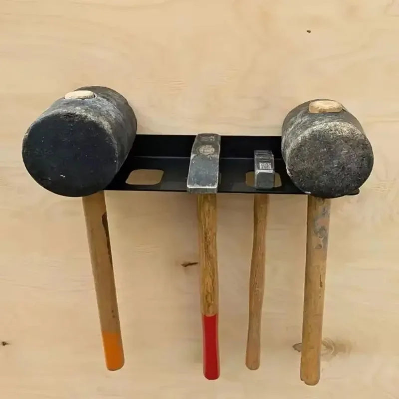 Metal hammer organizer rack fixed to a wooden wall with tools inserted
