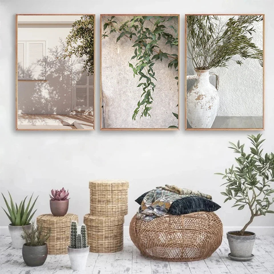 Set of three canvas wall art prints with botanical and architectural themes in a boho room