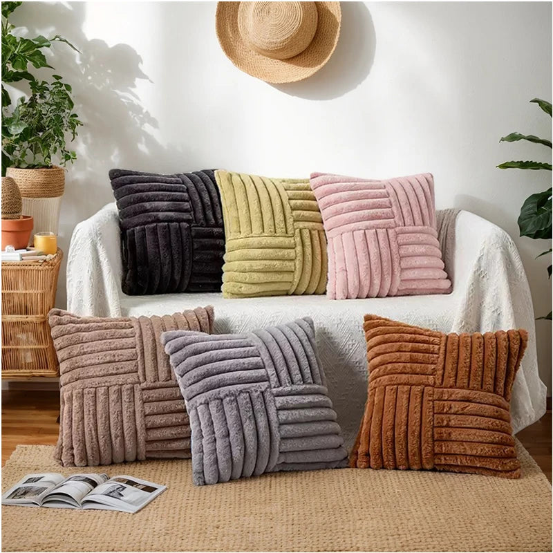 Assorted plush geometric pillow covers in multiple colors displayed on a sofa and floor