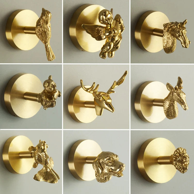Assorted brass animal wall hooks showing bird, angel, horse, and other animal shapes