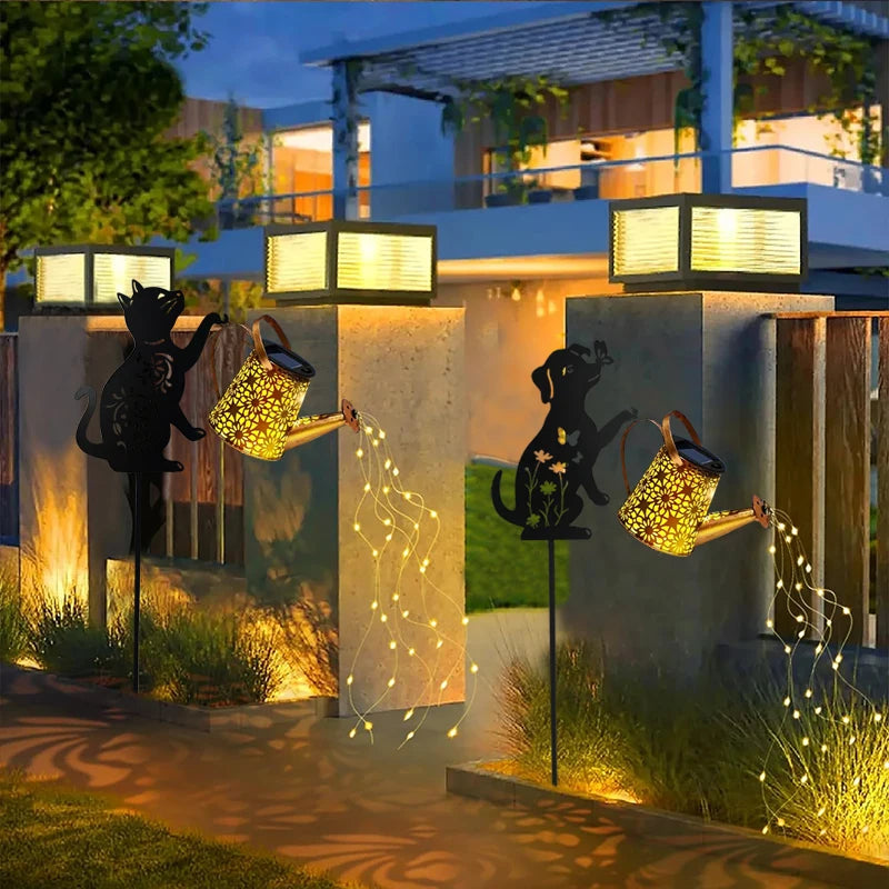 Pair of animal silhouette solar lanterns with watering cans, lighting up a modern garden entrance at dusk
