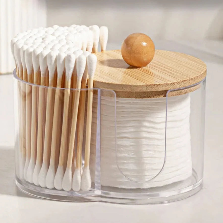 Divided cotton pad and swab organizer with clear body and wood lid on bathroom counter