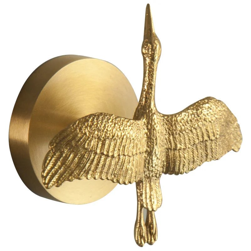 Brass wall hook shaped like a bird with outstretched wings