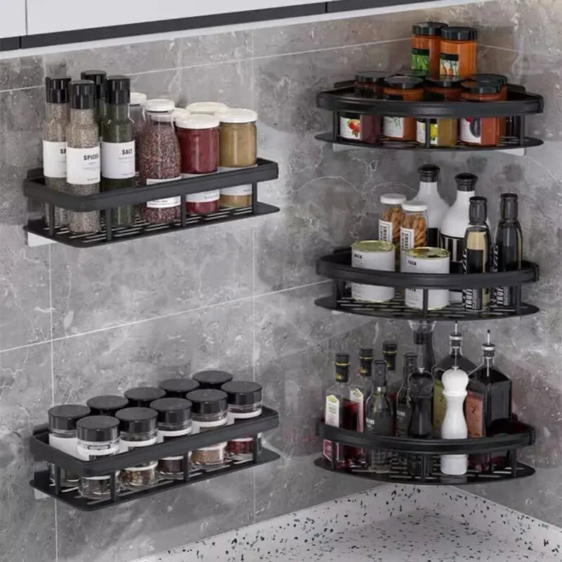 Close-up of black adhesive shelves for kitchen storage, holding jars, bottles, and cans.