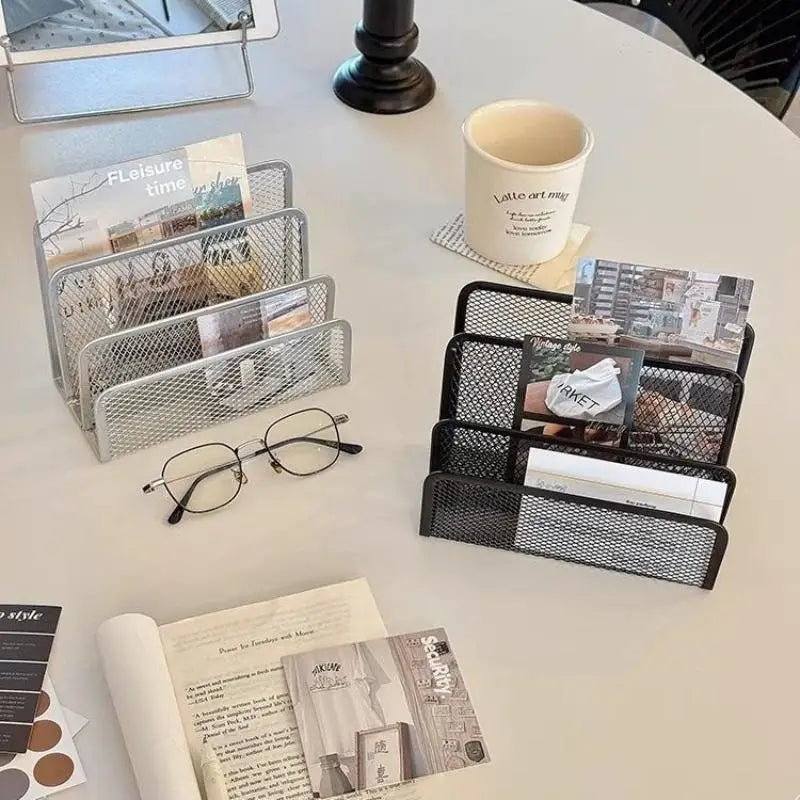 Black and silver mesh letter organizers side by side on a desk, each filled with mail and papers
