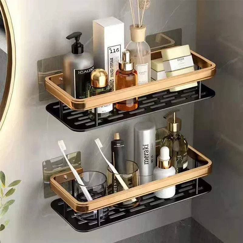 Black and gold rectangular wall-mounted organizer shelves with toiletries, toothbrushes, and small decor in a bathroom setting.