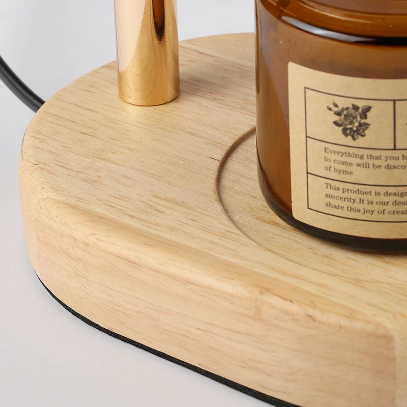 Close-up of the candle warmer lamp's rounded wood base with an amber jar candle