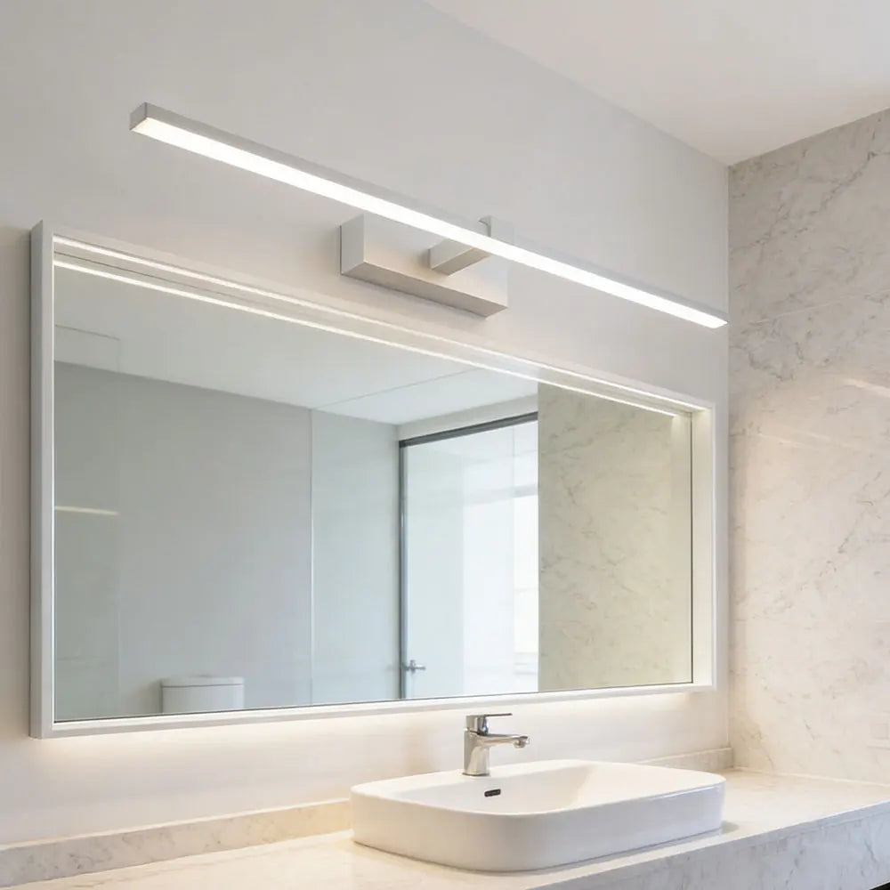 Modern LED vanity wall light installed above a large bathroom mirror