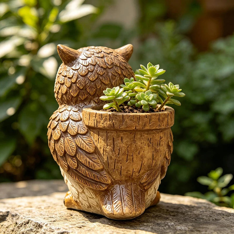 Back view of owl resin planter pot showing the container with succulent plant