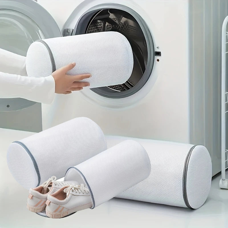 Person placing mesh shoe laundry bag into a front load washing machine with sneakers shown