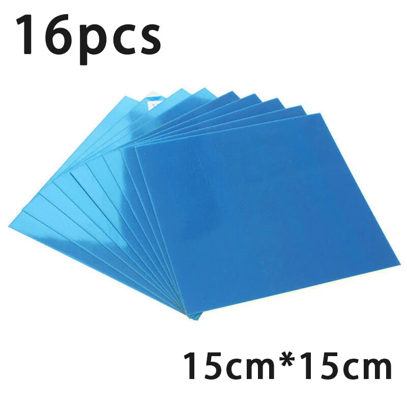 Stack of 16 square self-adhesive mirror tiles with blue protective film, labeled 15cm by 15cm