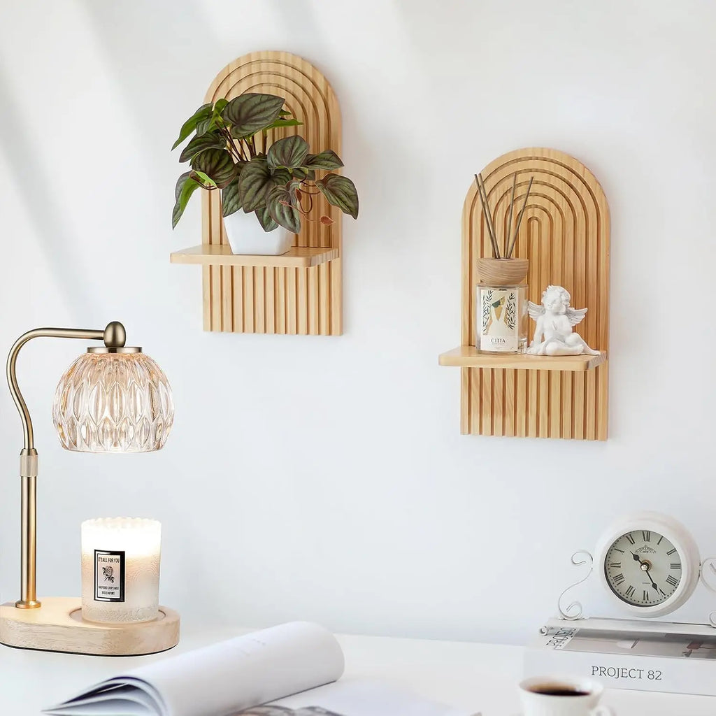 Arched wood wall shelves styled with a plant, angel figurine, and reed diffuser on a desk