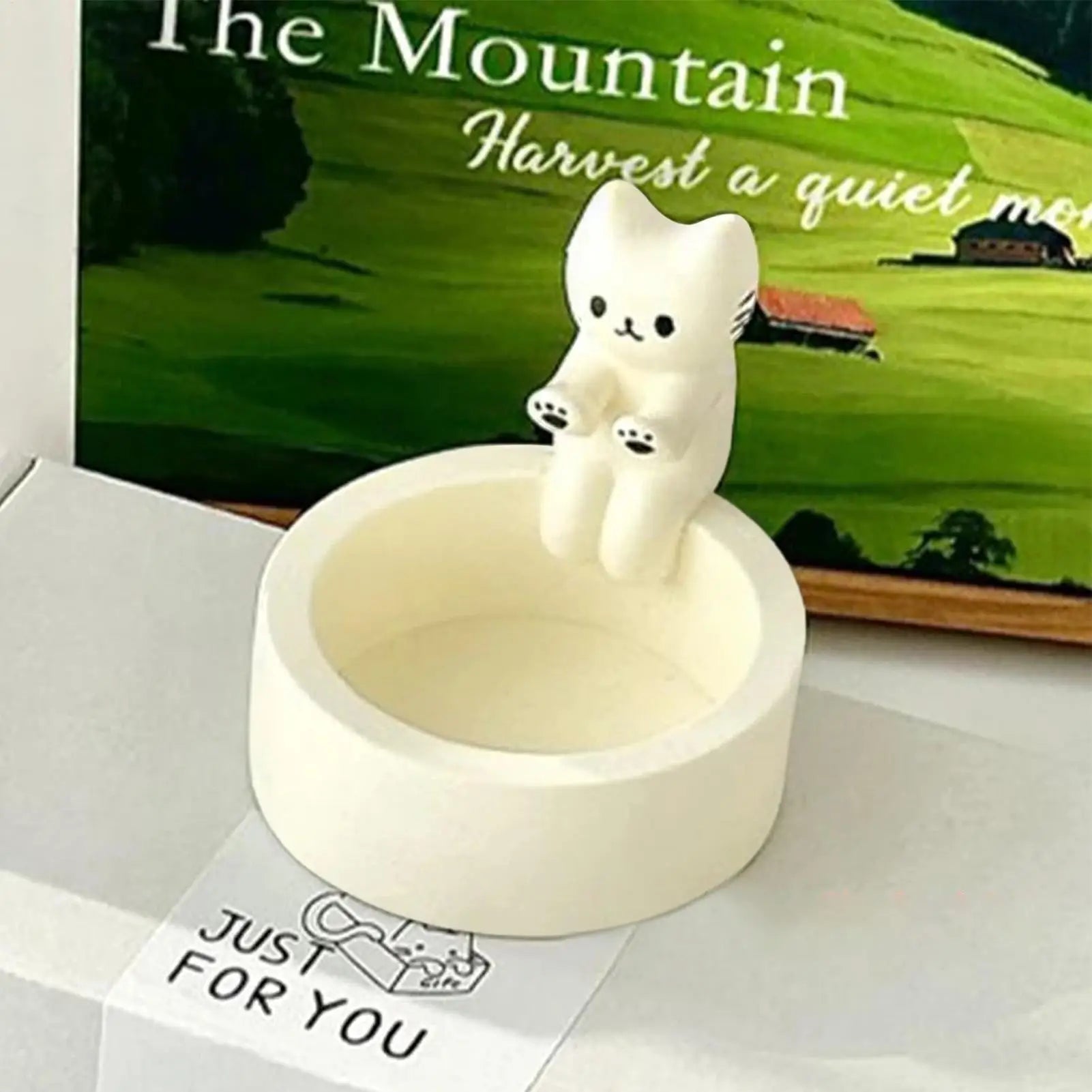resin cat shaped tealight candle holder on desk