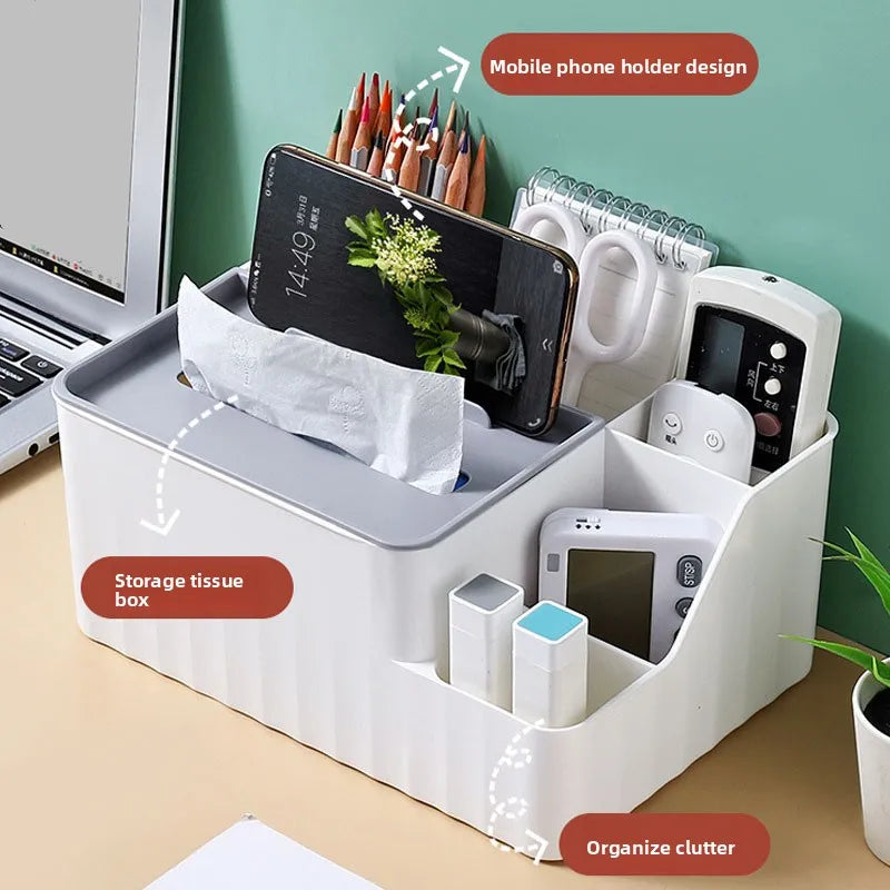 White plastic desk organizer holding phone, pencils, remotes, small accessories, and tissues.