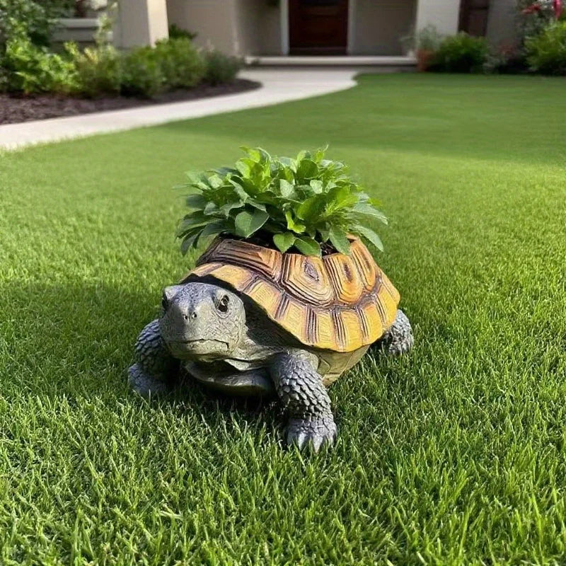 Turtle-shaped resin planter with leaves in front of a house entrance