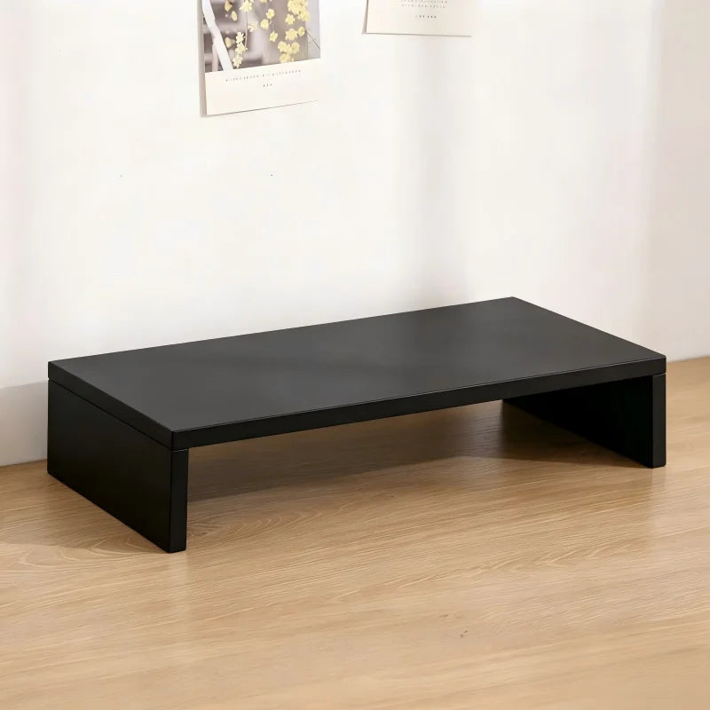 Black U-shaped wooden monitor riser stand displayed on a light wood floor.