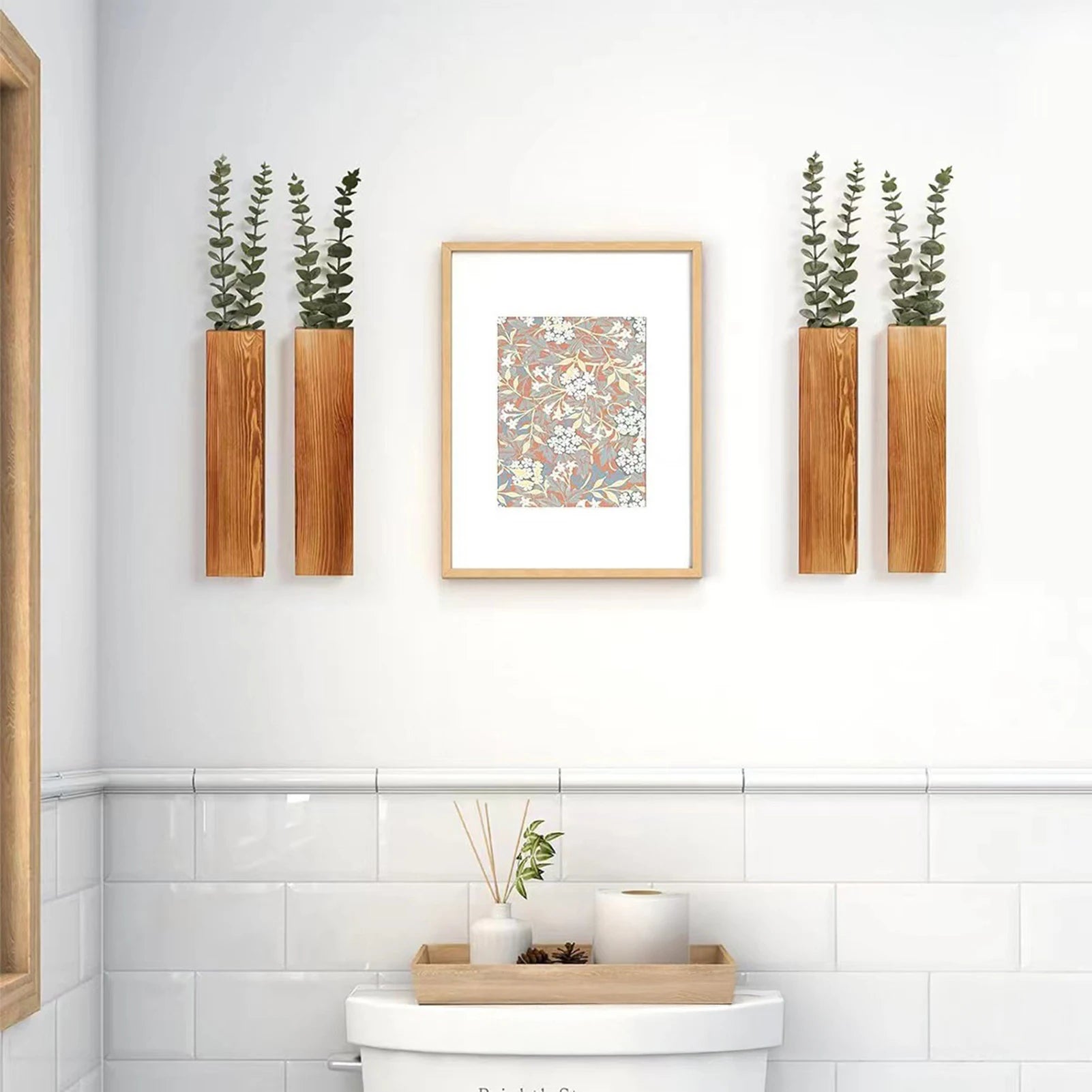 wooden wall planters with faux stems flanking wall art in a bathroom above a toilet