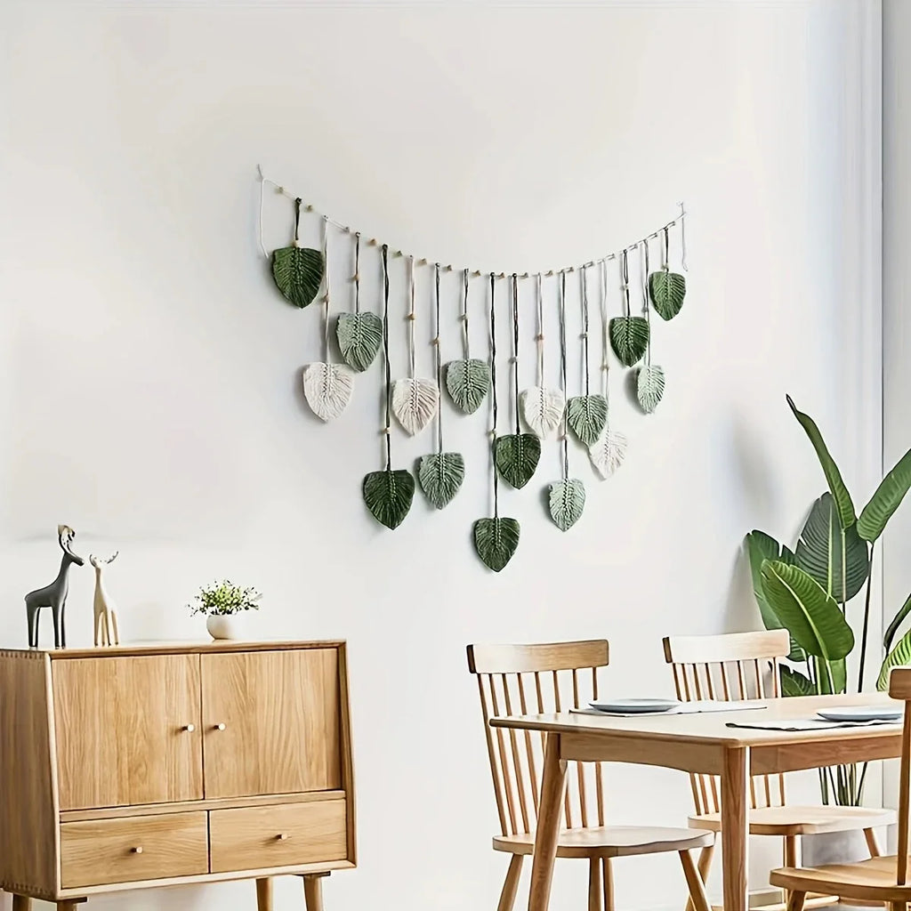 Leaf macrame wall garland in a modern dining area with wooden furniture