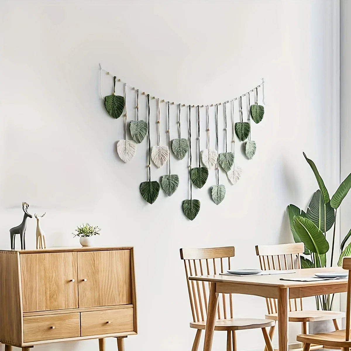 Leaf macrame wall garland in a modern dining area with wooden furniture