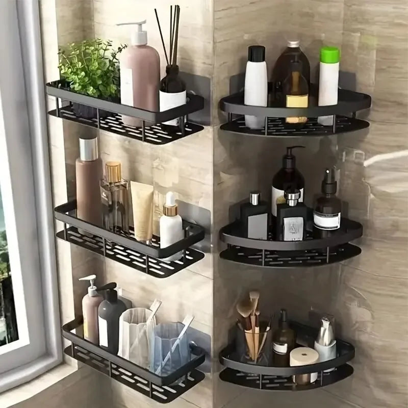 Black rectangle and triangle adhesive corner shelves mounted in a bathroom holding toiletries and plants.