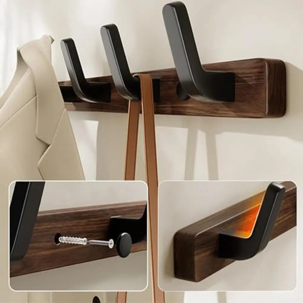 Close-up of wood and black metal wall-mounted coat rack holding a coat and bag, with detail insets showing mounting hardware and hook design