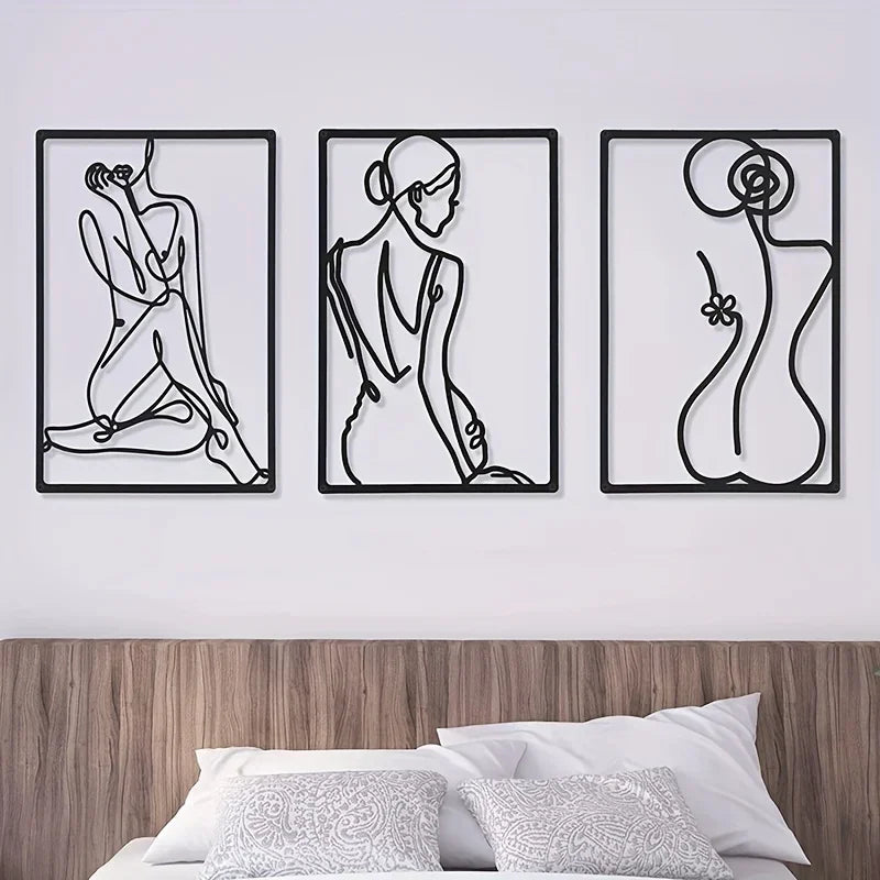 Abstract metal line wall art set of three, arranged above a bed with neutral bedding for a modern bedroom look.