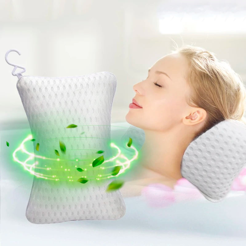 Woman resting head on a white bath pillow in the tub, product shown with leaves and a hanging hook