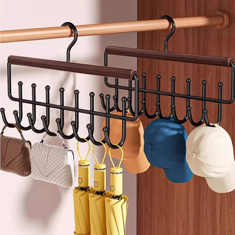 Two hook hangers in a closet holding hats, umbrellas, and small purses