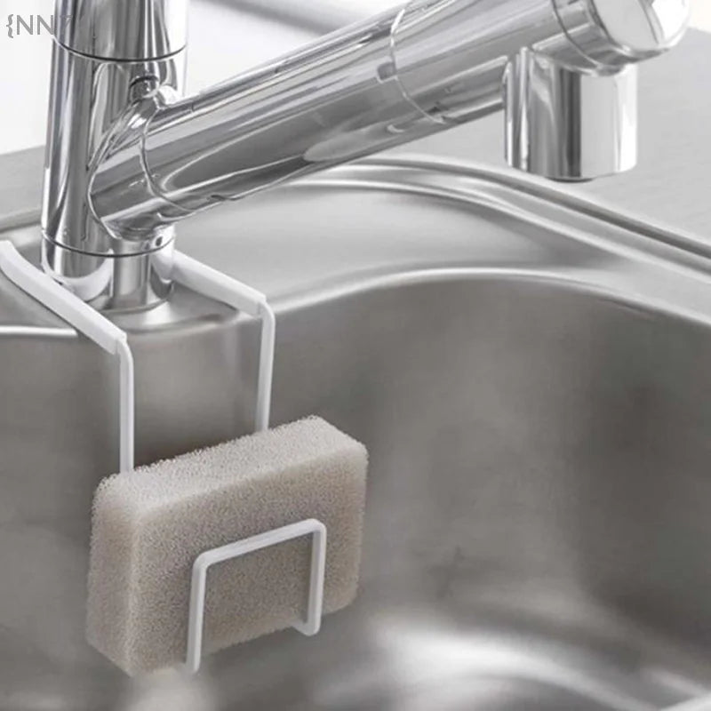 White metal sink caddy holding a sponge on a bathroom or kitchen faucet