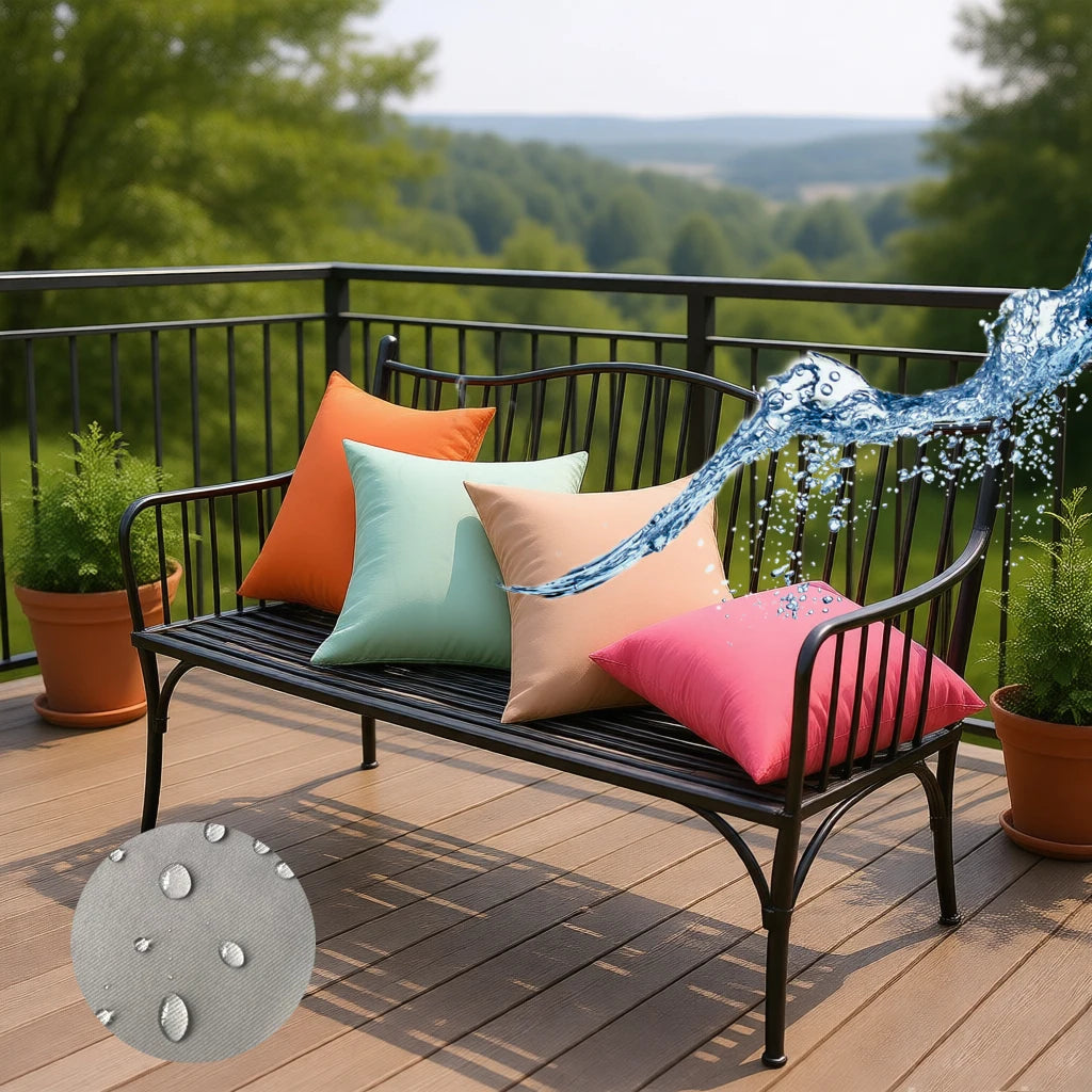 Assorted colorful outdoor cushion covers on a patio bench demonstrating water-resistance