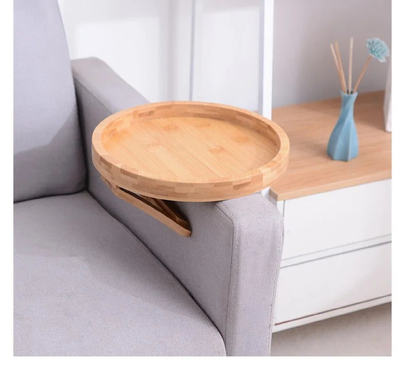 Empty bamboo tray clipped onto a light gray sofa arm in a modern living room