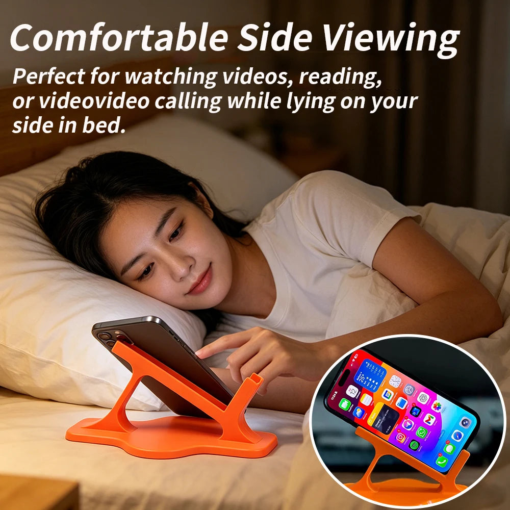 Person using orange plastic phone stand on bed for side viewing