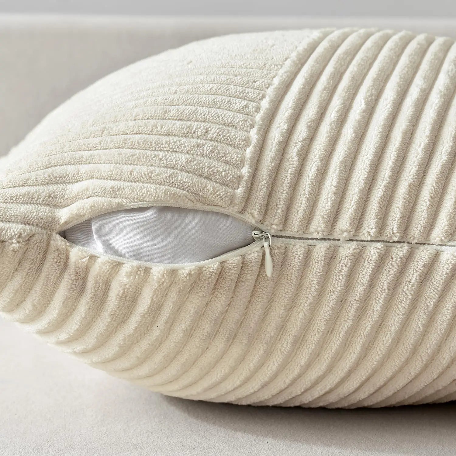 Detail showing zippered closure on textured corduroy pillow cover