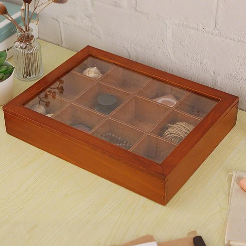 Wooden organizer with clear lid holding small items, closed on a desk