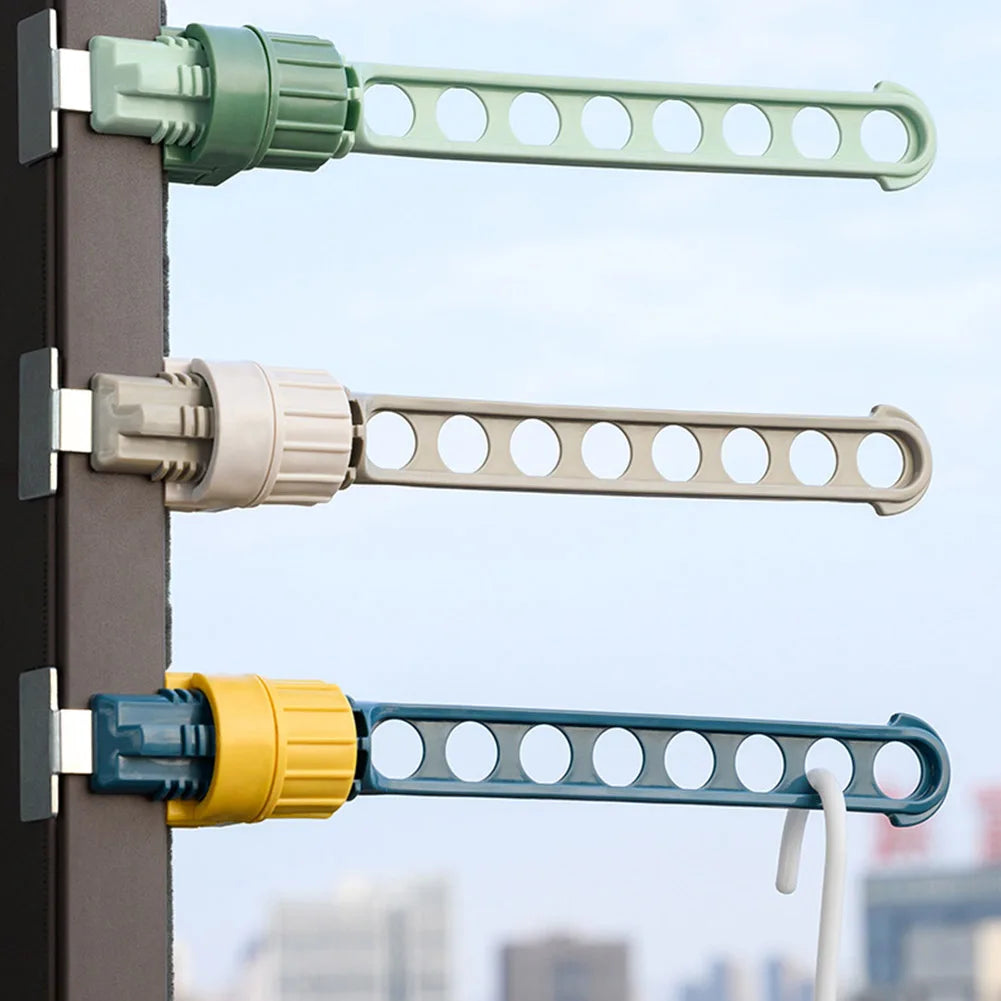 Three color options of wall-mounted clothes drying racks installed on a window frame, showing green, gray, and blue models with 8 holes each.