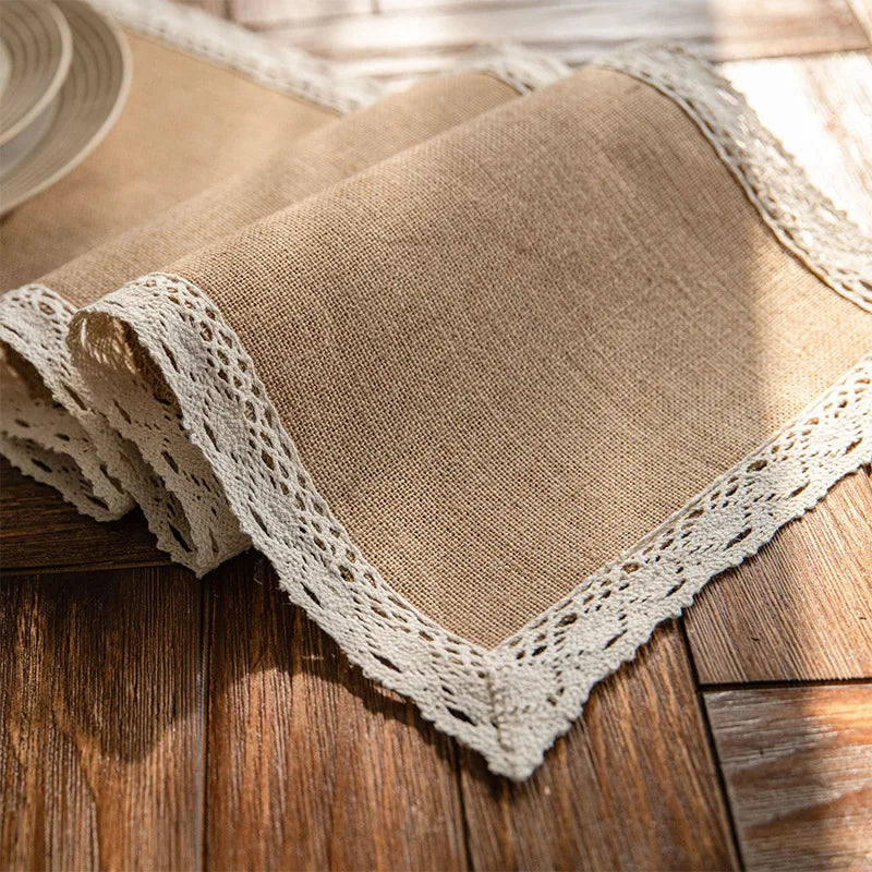 Vintage-inspired jute table runner with delicate lace trim, close-up detail