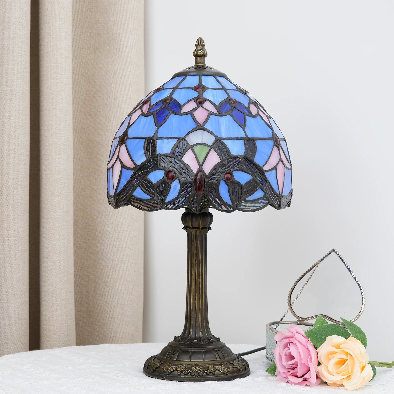 Blue stained glass table lamp on a side table in a living room setting