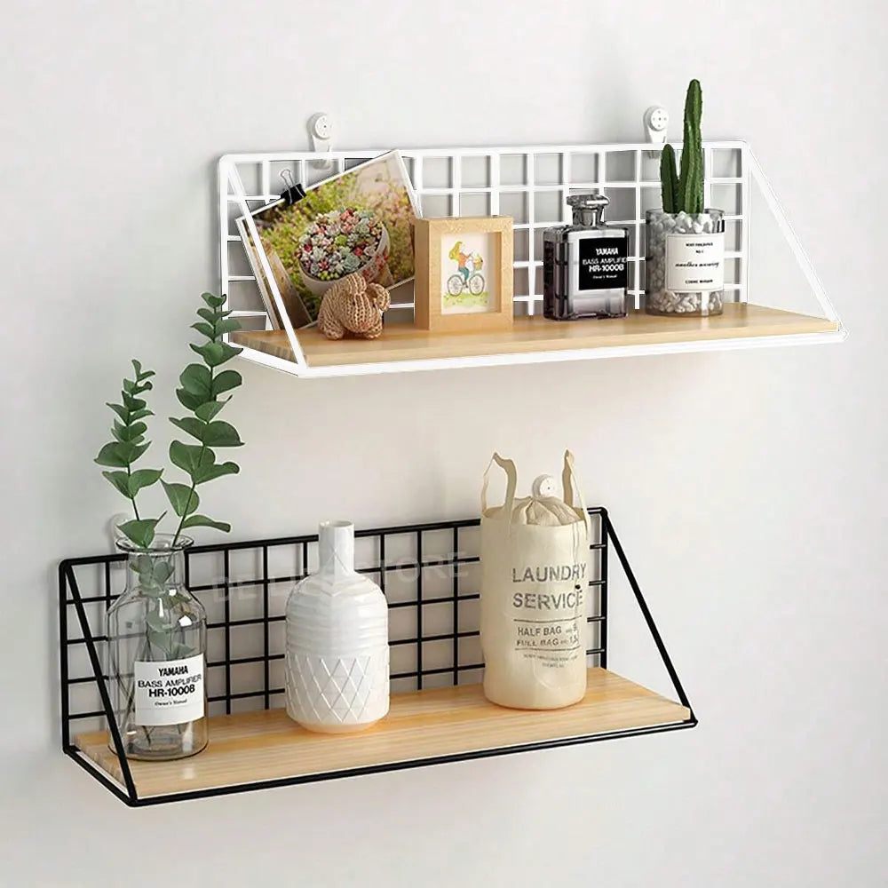White and black wall shelves displaying small decor, plants, and framed items in a bright room