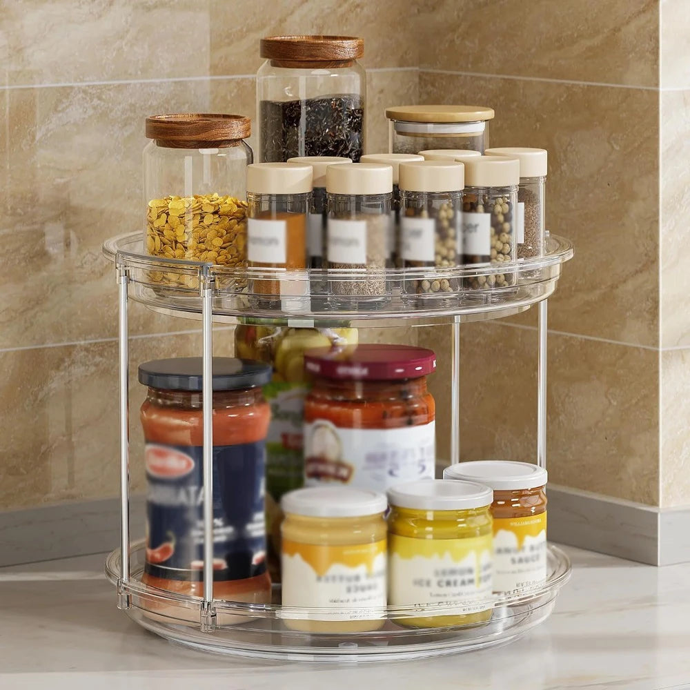 Clear 2-tier lazy Susan organizer with jars and spice bottles in a kitchen corner