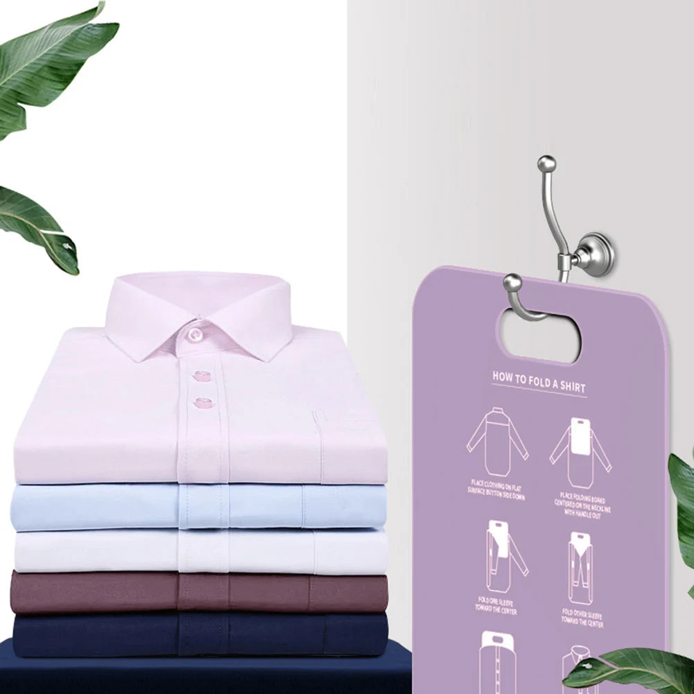 Purple folding board with folding instructions hanging on a hook next to a stack of folded shirts
