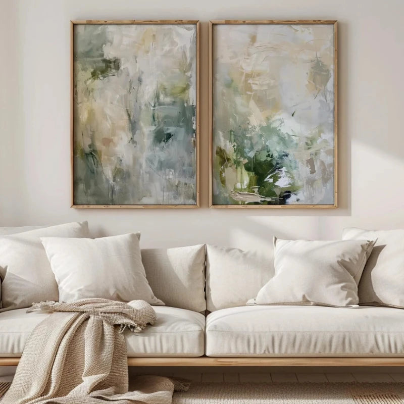 Neutral abstract canvas art set displayed above a light-colored sofa in a living room