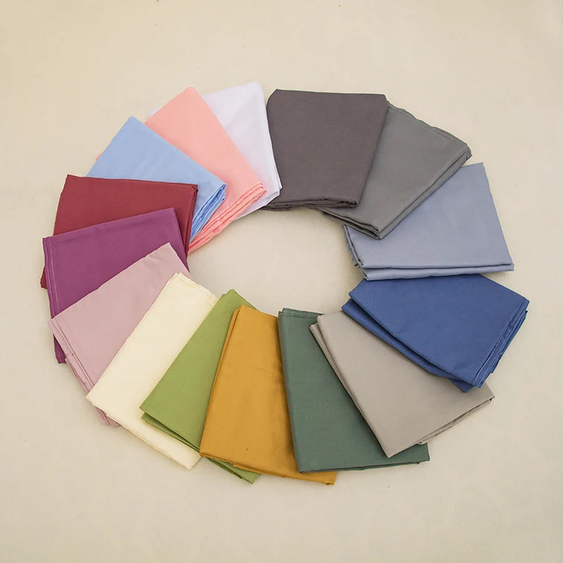 Assorted solid color pillowcases arranged in a circle to show color variety
