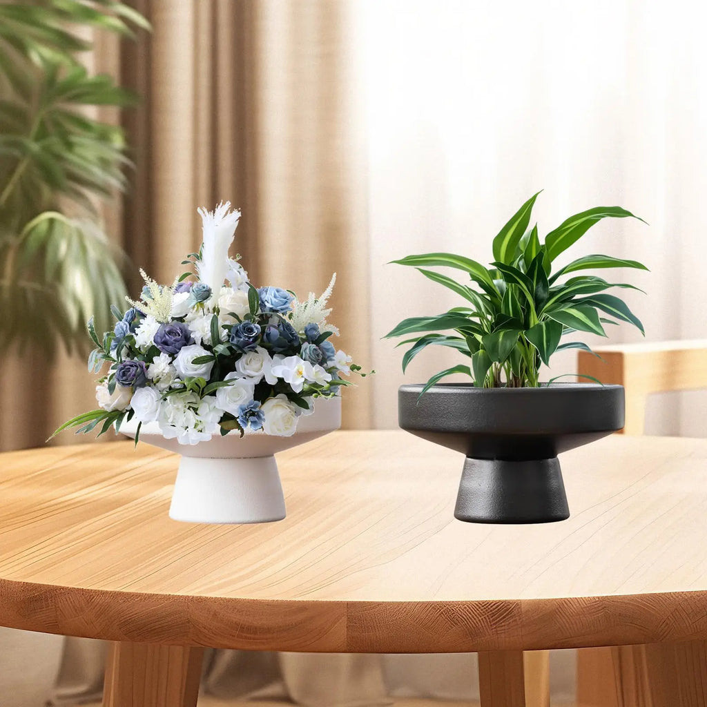 Pedestal ceramic flowerpots with flowers and plants on round wooden dining table