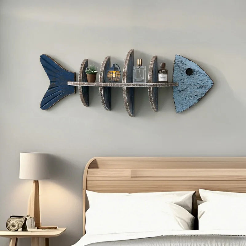 Fishbone wall shelf mounted above a bed holding small decor items