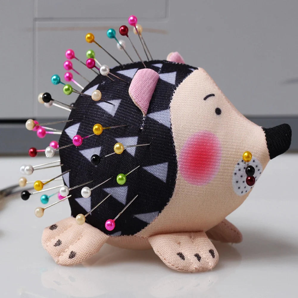 Hedgehog pin cushion for sewing on tabletop with colorful pins
