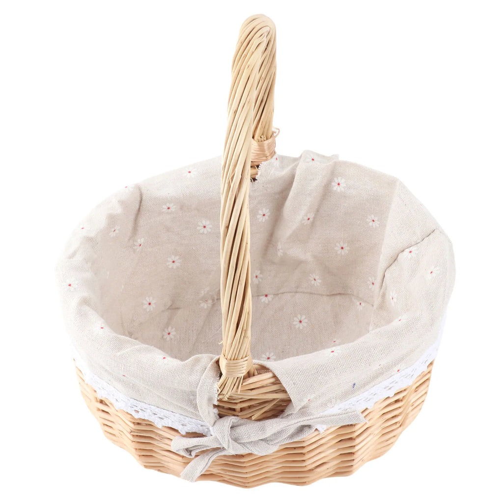 Angled view of oval rattan basket showing carry handle and bow