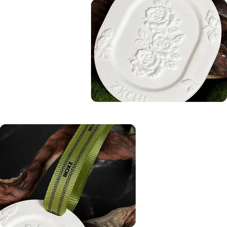 Close-up of embossed rose pattern and green ribbon loop on white gypsum hanging stone